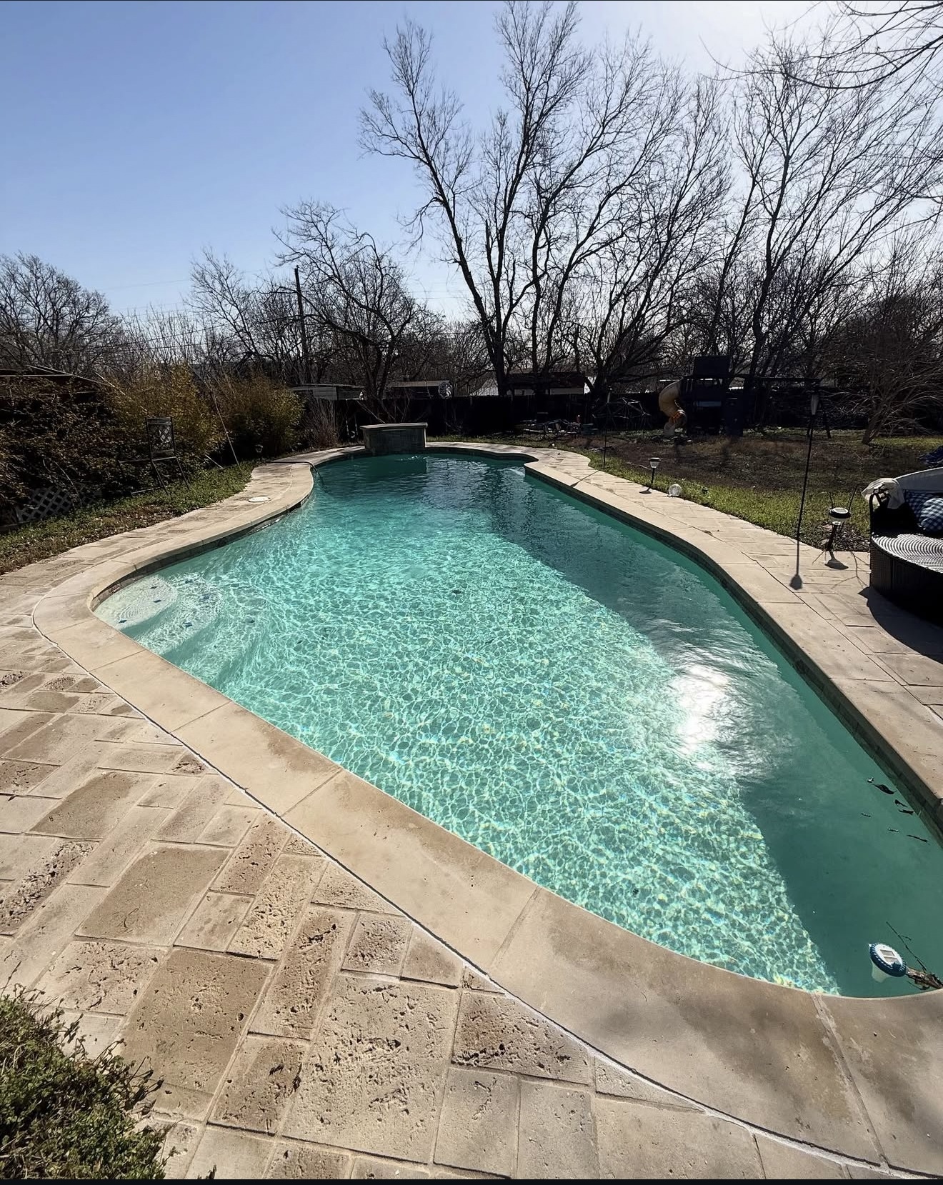 Refinished pool with sparkling water and stone coping